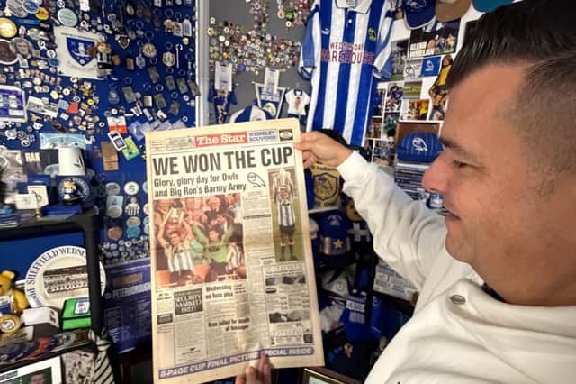 Luke Earnshaw, owner of The Wednesday Warehouse, with a copy of The Star after famous 1991 League Cup win.