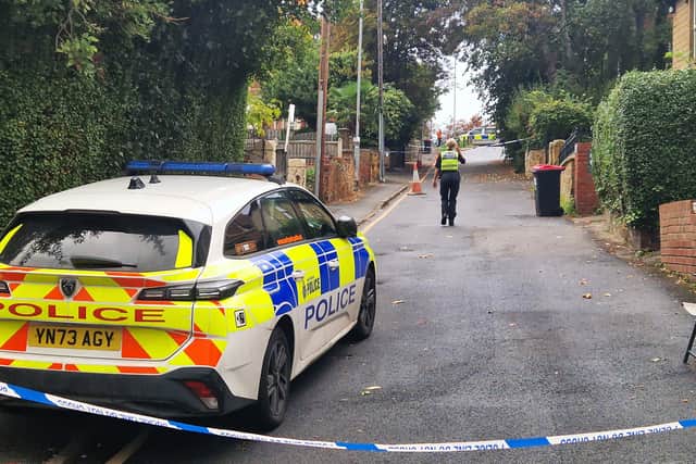 Police remain on the scene the morning after an explosion on Clifton Mount.