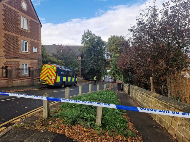Police remain on the scene the morning after an explosion on Clifton Mount.