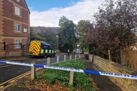 Police remain on the scene the morning after an explosion on Clifton Mount.