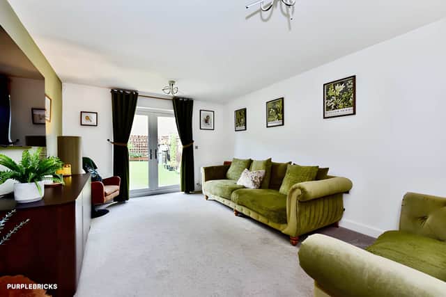 The generous lounge provides a substantial reception space on the ground floor of this three-storey family home