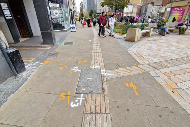 Spray paint indicates where 3ft trial holes will be dug on Fargate for a new power supply to Event Central.