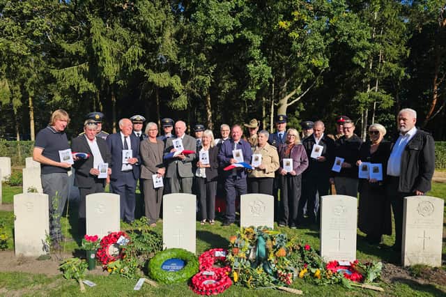 Family and military representatives at the  graves of Sheffield RAF hero John Tales and four others who died after the same bomber crashed. Photo: MOD