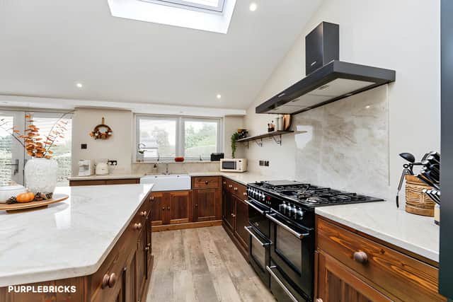 A spacious open kitchen and dining room provides generous room for both cooking and family meals