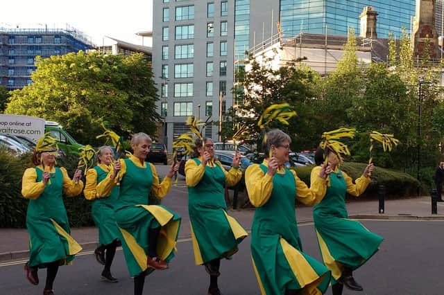 The dancers wear hard-soled or wooden-soled shoes, which are known as clogs, to create loud rhythmic sounds against the floor.