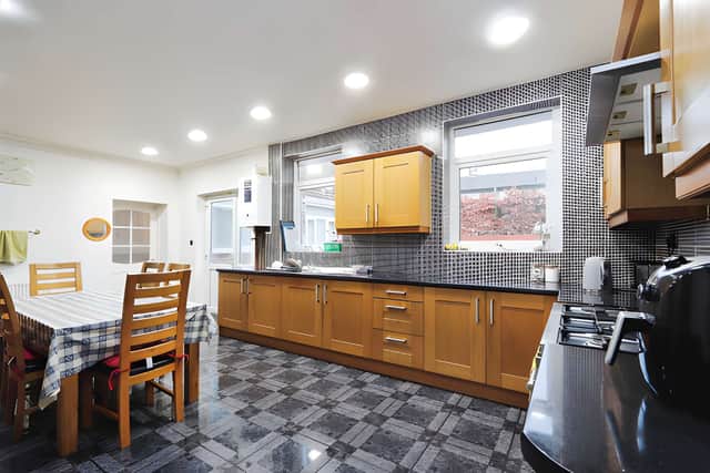 The sizeable kitchen features ample storage and counter space, with its position beside the separate dining room creating a practical arrangement for family meals