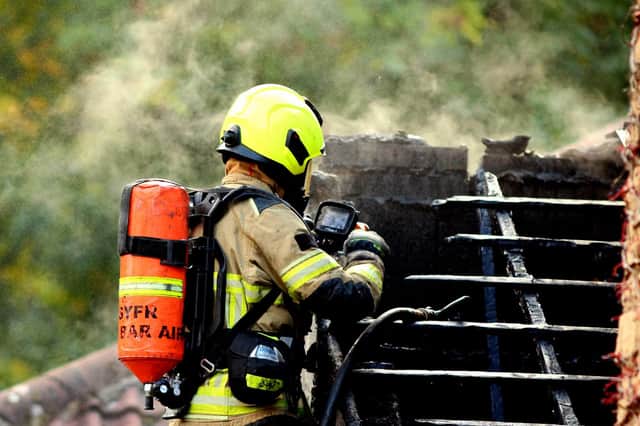 A firefighters next to the roof  at Waterside Gardens, Oughtibridge, Photos: South Yorkshire Fire and Rescue Service