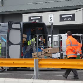 View of workers loading vans at an Amazon warehouse