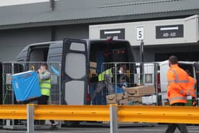 View of workers loading vans at an Amazon warehouse