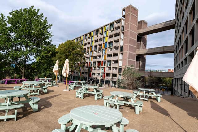 Outdoor seating looks up at iconic spray painted proposal
