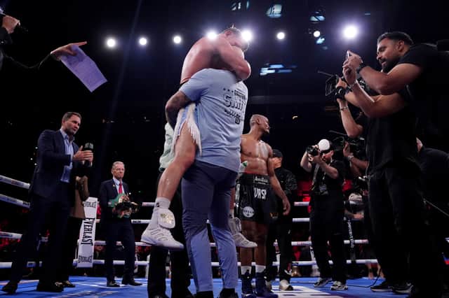 Dalton Smith (centre left) embraces his coach as he celebrates after being announced as the winner of the WBC World Super Lightweight Title Contest against Alberto Puello at Utilita Arena Sheffield.