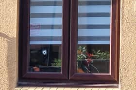 A bullet hole in the window of the Sheffield home