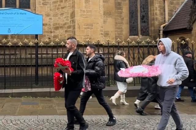 Flowers were carried from the Church, to the car, as mourners headed to a private service