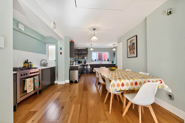 The open-plan kitchen and dining area creates a sociable hub, complemented by a separate utility room for everyday household tasks