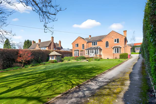 The detached house sits in a private residential setting off Green Lane, with extensive grounds and driveway parking adding to its appeal