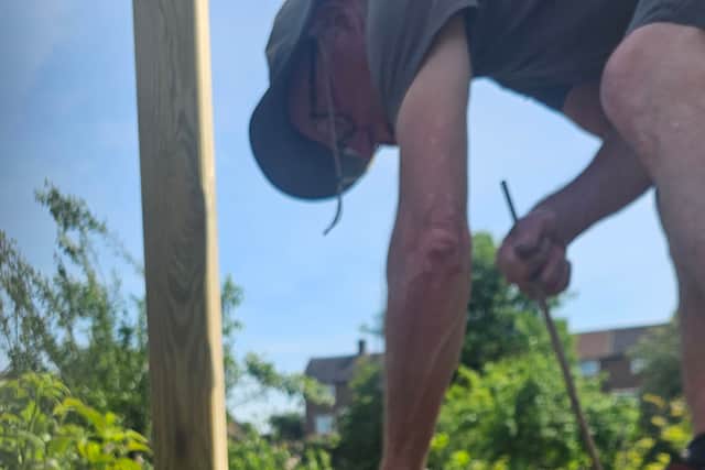 Dave planting in the community allotment