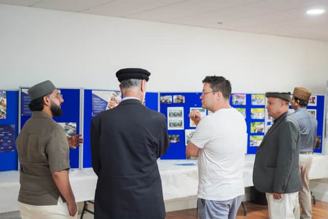 Viewing an exhibition showcasing the community’s environmental, humanitarian, and charitable activities.