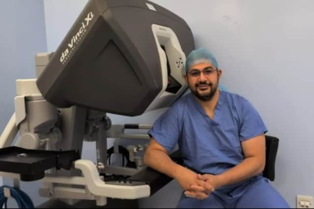 Mr Karim Addallah next to the Da Vinci surgical console