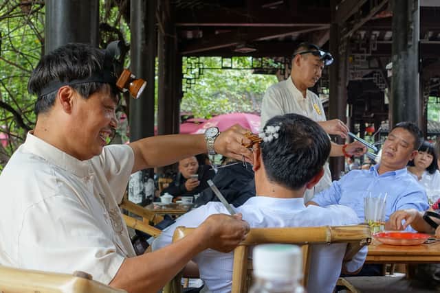 Residents having their ears picked in a Chengdu tea house