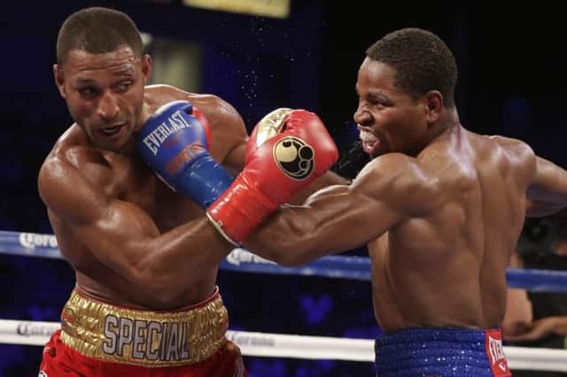 Shawn Porter, right, and Kell Brook trade punches during their IBF welterweight title boxing bout Saturday, Aug. 16, 2014, in Carson, Calif.