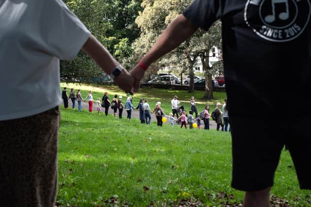 People li king hands around the historic Meersbrook Hall in Sheffield