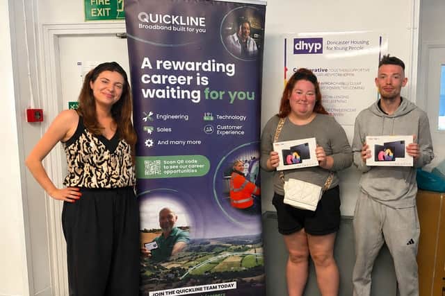 Doncaster Housing for Young People receiving the tablet donation from Quickline.