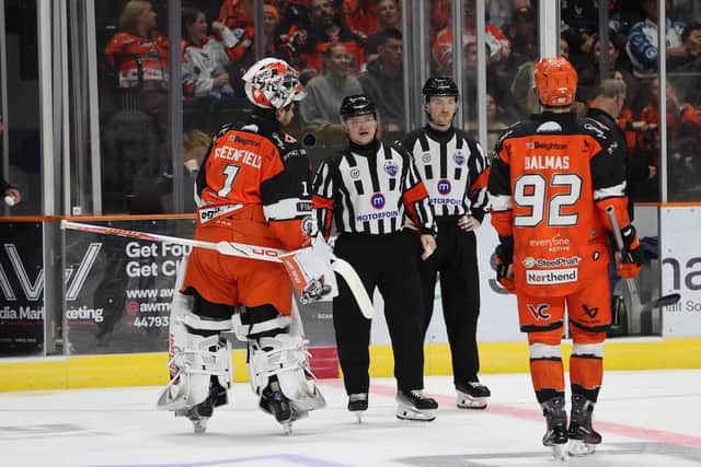 Goalie Matt Greenfield and Mitchel Balmas question the goal decision