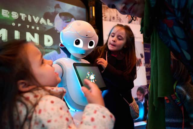 A family meeting a robot at Festival of the Mind 2024
