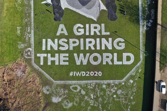 The painting, which has taken a week to complete, features the words "A GIRL INSPIRING THE WORLD #IWD2020" and includes the childrens own artwork around the outside. Pic: Guzelian