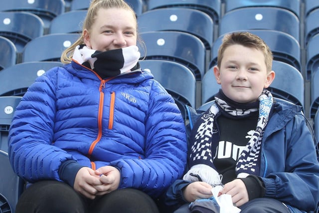 Two Preston fans smile for the camera as they wait for the players at Deepdale.