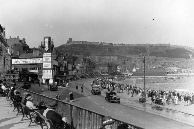 A view of the Foreshore in 1935 with advertisements for Lady Wrestlers in the background.