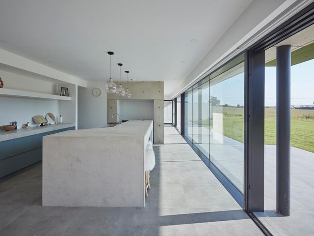 Barrow House, North East Lincolnshire, by ID Architecture. The simple above ground barn form was true to the agricultural language in the area with a projecting master bedroom pod that would reach out over the site towards the Bronze Age Barrow within the valley. Photo: Andy Haslam