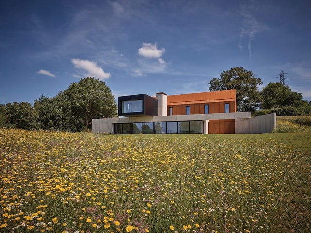 Barrow House, North East Lincolnshire, by ID Architecture. The barn sits on the below ground concrete plinth forming the entrance and subterranean living spaces with a strong connection with the site. Photo: Andy Haslam