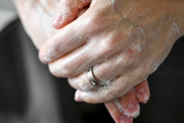 You should wash your hands for the amount of time it takes to sing "Happy Birthday" twice (around 20 seconds), using enough soap to cover your hands and warm water. You should rub all parts of your hands when washing them, including between your fingers and the back. Use hand sanitiser when soap is not available.