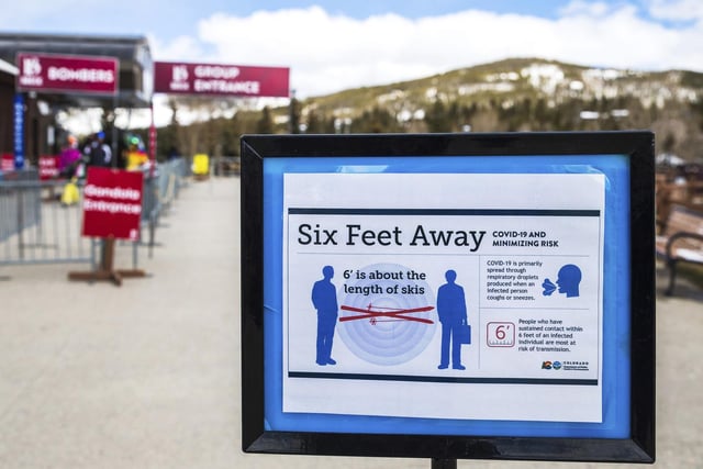 A sign near the Breckenridge Ski Resort gondola in Breckenridge, Colorado, outlines public health guidelines about social distancing.