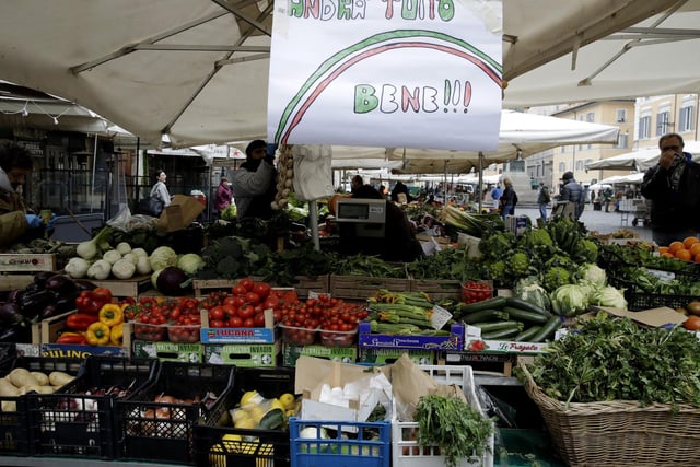 A banner reading 'Everything will be alright' is placed at Rome's Campo Dei Fiori market.