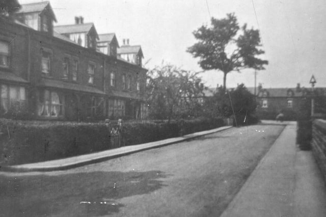 Looking north along Church Lane. In the distance Church Lane bears left by the junction with Sandbed Lane. Another row of terraced houses, Roseville Terrace, faces the camera on the right.
