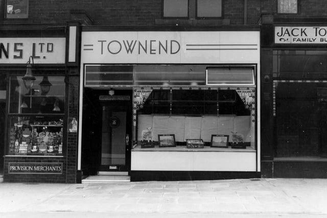 Townend butchers shop on Austhorpe Road with advertisements for New Zealand lamb. To the left is Gallons grocers.