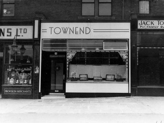 Townend butchers shop on Austhorpe Road with advertisements for New Zealand lamb. To the left is Gallons grocers.