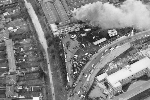 An aerial view of Cross Gates Carriage Works on Manston Lane. A small fire is being attended to by several engines. Nine metro buses worth 120,000 pounds each had to be pushed to safety.