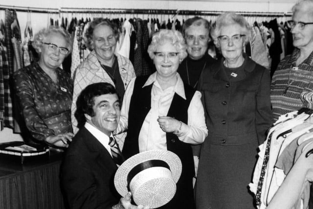 Frankie Vaughan serenading helpers at an Oxfam shop in Leeds. From left, Jessie Hull, Lavinia Braid, Jessie Sunderland (chairman of the Aireborough Oxfam Group),  Molly Finch, Kathleen Maud and Dorothy Emsley.