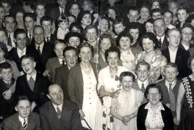 A large group gather for a photograph at a dance at the Co-Op Hall in Morley.