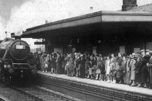 A crowd of people on the platform of Morley Top Station waiting for the train to Cleethorpes. They were members of the Cross Church Street Working Men's Club along with their families, on what was to become an annual trip to the seaside.