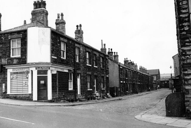 Little Fountain Street from Fountain Street. On the corner is Fountain Street, tobacconist and confectioners shop. In the background part of Field Woollen Mills can be seen at the end of Little Fountain Street.