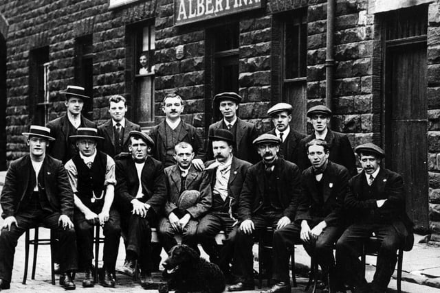 A group of men, with a dog, outside the Albert Inn, on Albert Road, Morley. The occasion is not known. The inn itself was part of a terrace, Albert Row, near to the Miners Arms public house, and Morley station.