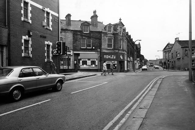 Looking from High Street toward the junction with South Queen Street, Fountain Street and Queen Street. On the left is the Pavilion Bingo and Social Club. Across the road is a butcher's shop, then James Ashley, menswear.