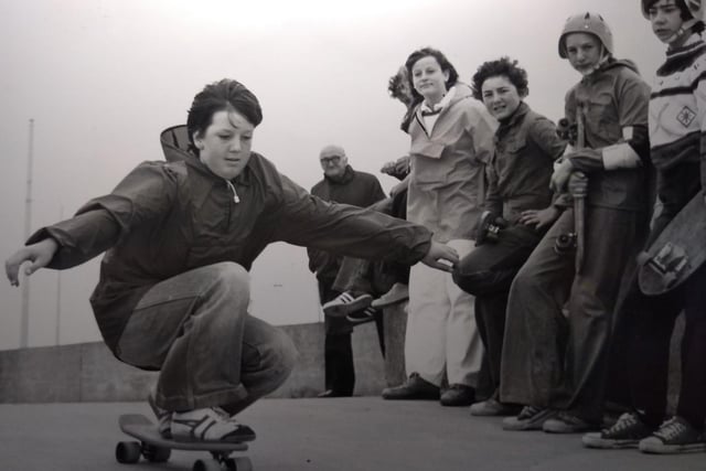 Mark Rowlands shows some skateboarding tricks, watched on by friends in 1977