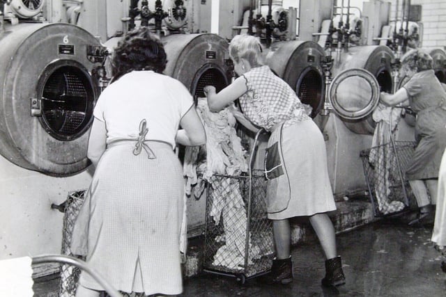 Clothes go into the washing machine at the start of a two hour wash at Kirkstall Road wash house which cost 3s and 6d.