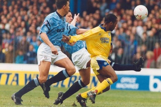 It proved to be a bad day at the office for the Whites at Maine Road. Rod Wallace's progress towards goal is hampered by a shirt pull from Keith Curle.