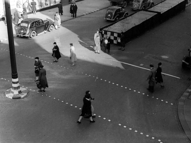 Pedestrians crossing The Headrow near Lewis's department store. Pictured in October 1944.